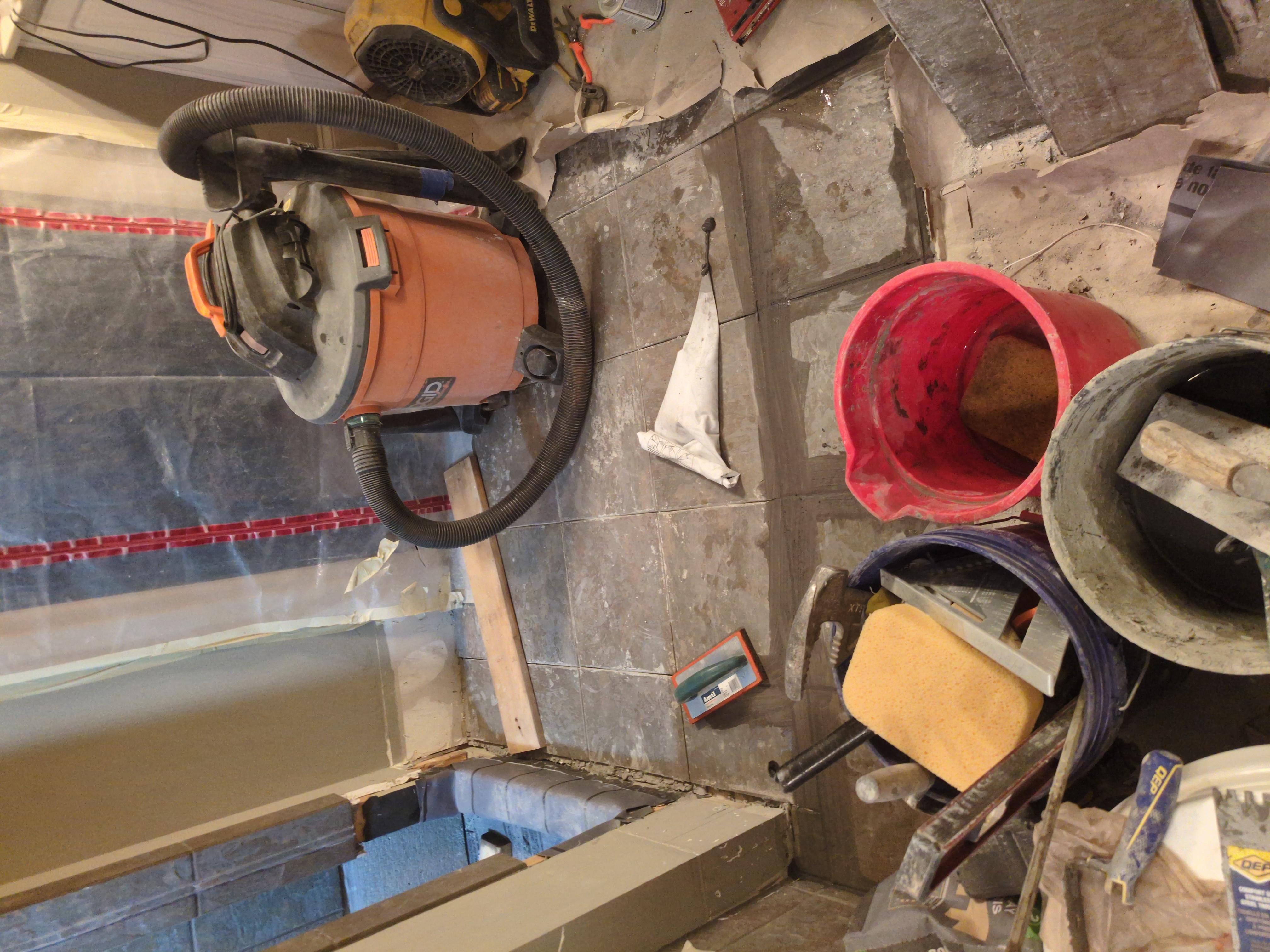 Cleaning up construction debris during a bathroom gut in Athens GA